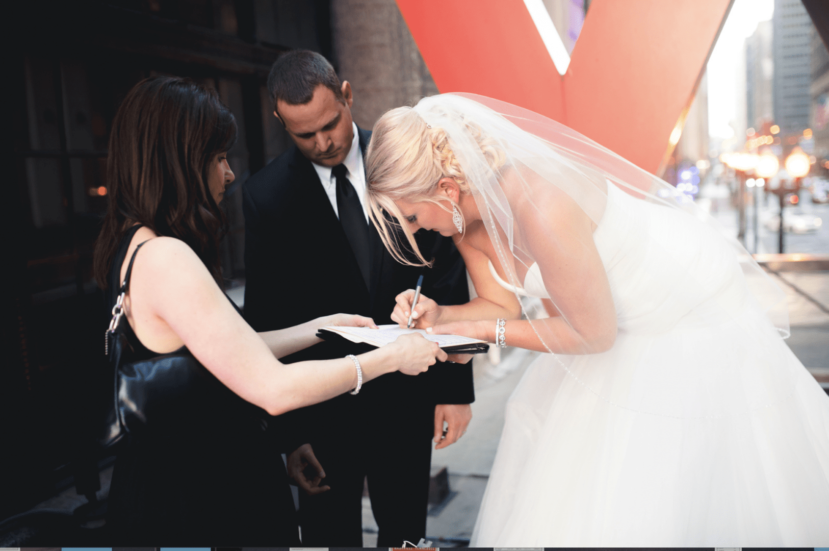 A bride signing her wedding day papers
